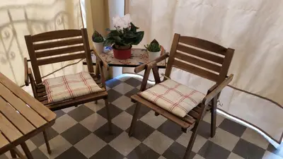 two chairs and a table with a potted plant at Duchi in Palermo