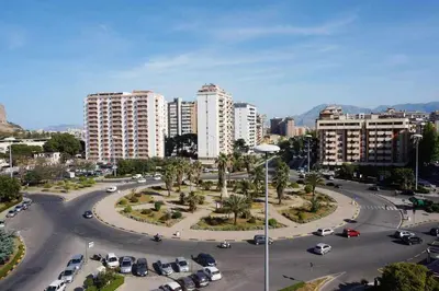 a city with cars parked in a parking lot at Favorita suites in Palermo