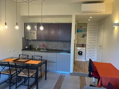 a kitchen with a table and a kitchen with a washer at Favorita suites in Palermo
