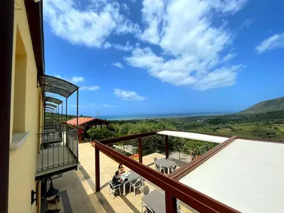 a balcony of a building with a view of the ocean at Agriturismo le Campanelle - Sicilia - Cefalù in Lascari