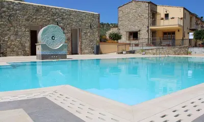 a large swimming pool in front of a building at Agriturismo le Campanelle - Sicilia - Cefalù in Lascari