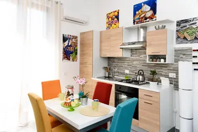 a kitchen and dining room with a table and chairs at Capo House in Palermo