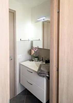 a bathroom with a white sink and a mirror at Capo House in Palermo