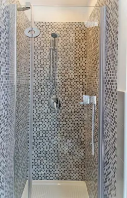 a shower with a glass door in a bathroom at Capo House in Palermo