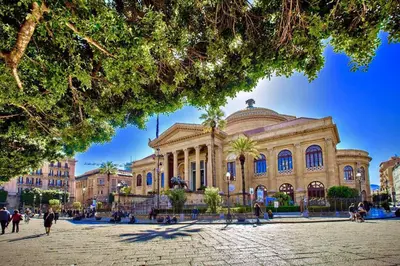 a large building with people walking in front of it at Capo House in Palermo