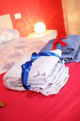 a pile of towels sitting on top of a bed at Casa Vacanze Aurora in Balestrate