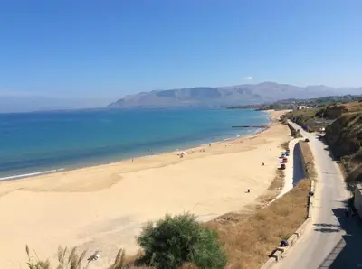a view of a beach with people in the water at Casa Vacanze Aurora in Balestrate