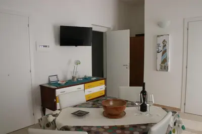 a living room with a table with a bottle of wine at Casa Vacanze Aurora in Balestrate
