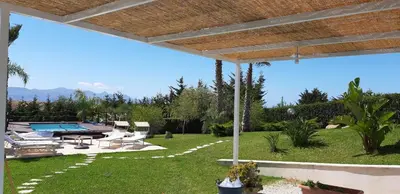 a yard with a swimming pool and a patio at Isola del sole, Appartamenti con piscina in Balestrate