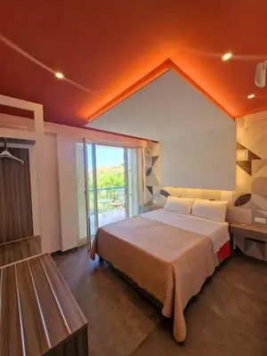 a bedroom with a large bed and a large window at Mongibello Palace B&B in Mondello