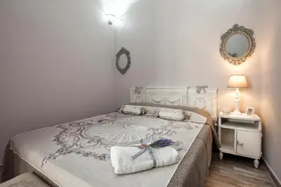 a bedroom with a large bed with two towels on it at Le Alcove in Cinisi