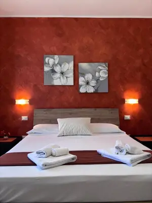 a bedroom with a bed with towels on it at B&B La Chiocciola in Castelluzzo