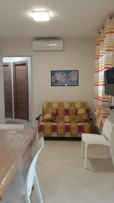 a living room with a couch and a tv at Casa Vacanza Demi in Alcamo Marina