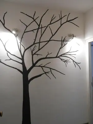 a tree mural on a wall in a room at Appartamento san Domenico in Palermo