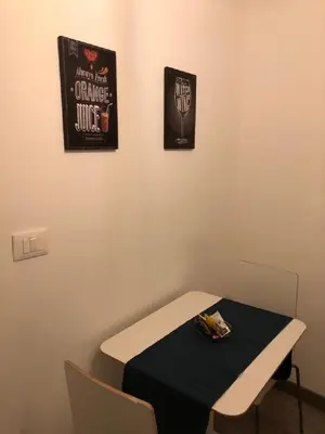 a room with a table and two posters on the wall at Appartamento san Domenico in Palermo