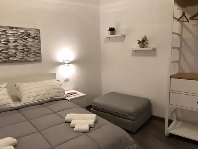 a small bedroom with a bed and a stool at Appartamento san Domenico in Palermo