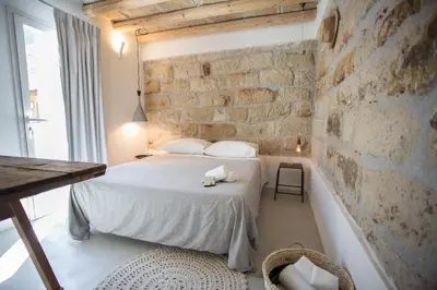 a bedroom with a bed and a brick wall at Settegrana in Cinisi