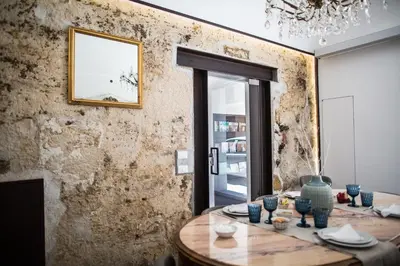 a dining room with a table with blue glasses on it at Settegrana in Cinisi
