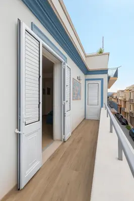 an open door on a building with a balcony at Matilde Boutique Hotel by AR Group Hotels in Isola delle Femmine
