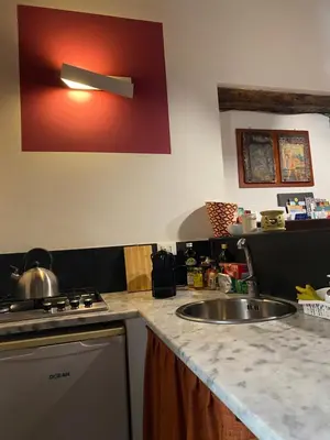 a kitchen counter with a sink and a stove at 3Sisters Apartments in Palermo