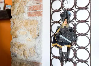 a doll is sitting on a iron fence at 3Sisters Apartments in Palermo