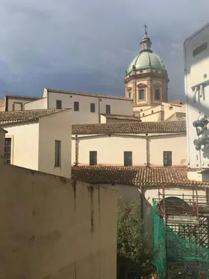 a building with a clock tower in the background at Ballarò Holiday in Palermo