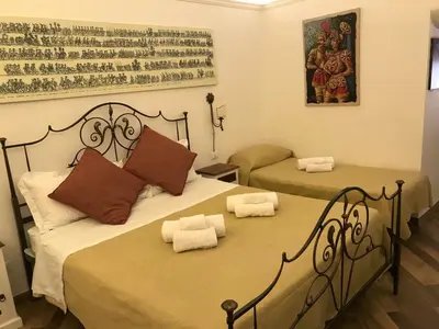 two beds in a room with two beds sidx sidx sidx sidx at Ballarò Holiday in Palermo