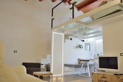 a living room with a couch and a television in a room at Uloft Apartment Palermo in Palermo