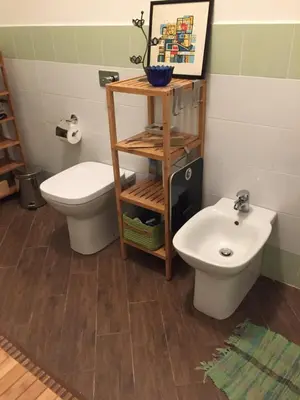 a bathroom with a toilet and a sink at Uloft Apartment Palermo in Palermo