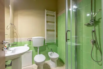 a bathroom with a toilet and a sink and a shower at Sant'Agostino Apartment by DomuSicily in Palermo