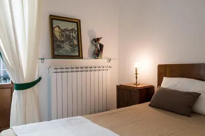 a bedroom with a bed and a radiator and a window at Sant'Agostino Apartment by DomuSicily in Palermo