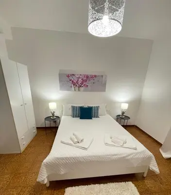a bedroom with a white bed with two towels on it at Villa sul mare Palazzolo in Trappeto