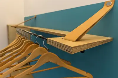 a row of wooden hangers in a room at Casa Colibrì - Solemar Sicilia in Santa Flavia