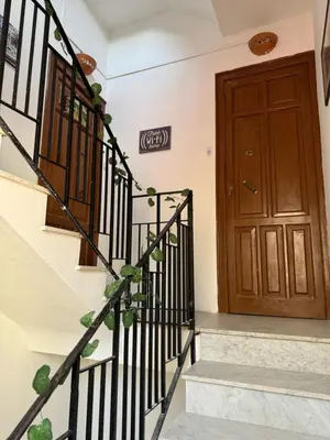 a set of stairs leading to a wooden door at Holiday mondello in Mondello