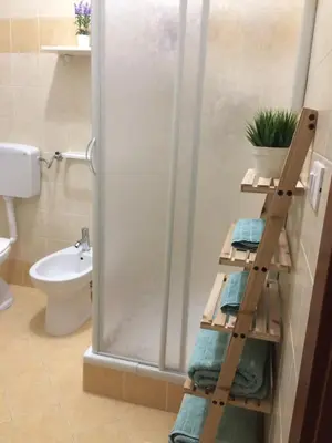 a bathroom with a shower with a ladder and towels at Ca&Sa Sweet Holiday in Cinisi