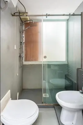 a bathroom with a toilet and a glass shower at Charming loft con Terrazze al Teatro Massimo in Palermo