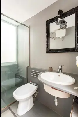a bathroom with a sink and a toilet and a mirror at Charming loft con Terrazze al Teatro Massimo in Palermo