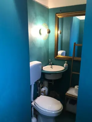 a bathroom with a toilet and a sink and a mirror at Charming loft con Terrazze al Teatro Massimo in Palermo