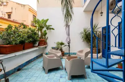a patio with chairs and plants on a building at Charming loft con Terrazze al Teatro Massimo in Palermo