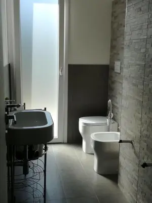 a bathroom with a toilet and a bidet and a sink at Villa Limone in Castellammare del Golfo