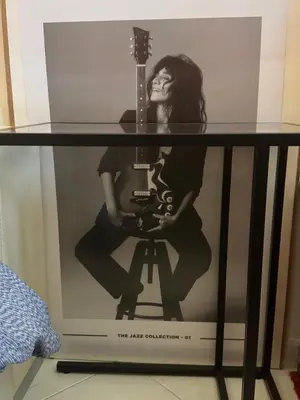 a glass table with a woman with a guitar on it at Palace Bed & Breakfast in Salaparuta