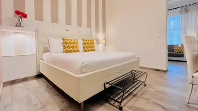 a bedroom with a large white bed with orange pillows at Villa di Nera B&B in Palermo