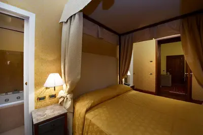a bedroom with a bed in a hotel room at Grand Hotel Piazza Borsa in Palermo