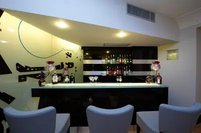a bar with blue chairs in a room at Grand Hotel Piazza Borsa in Palermo