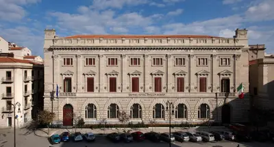 a large building with cars parked in front of it at Grand Hotel Piazza Borsa in Palermo