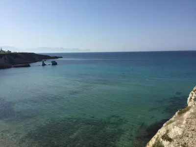 a view of the ocean from a cliff at Charm Holiday in Terrasini