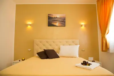 a bedroom with a large bed with two pillows on it at Charm Holiday in Terrasini