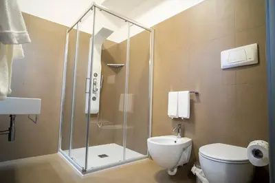 a bathroom with a shower and a toilet at Enny Camere in Alcamo