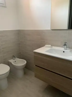 a bathroom with a sink and a toilet and a mirror at Casa Vacanze Astori in Trabia