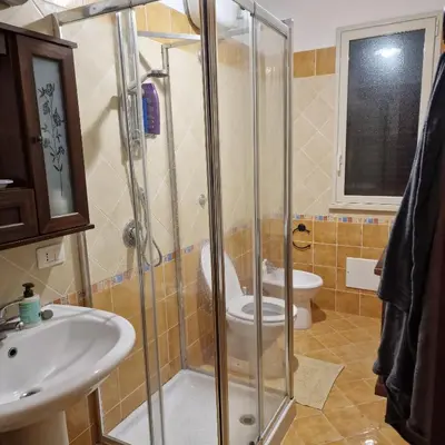 a bathroom with a shower and a toilet and a sink at La Villetta di Leonardo, con piscina privata in Campofelice di Roccella